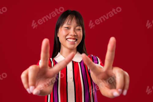 Preview: Beautiful asian woman portrait, asian woman showing peace sign smiling happy