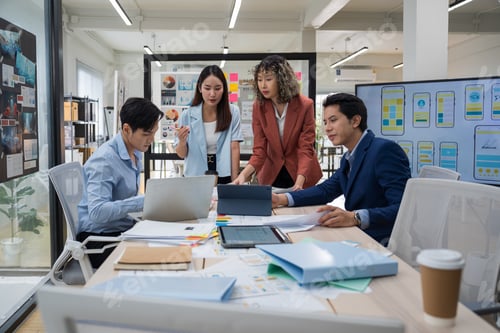 Preview: Group of young Asian business people team meeting in modern office working