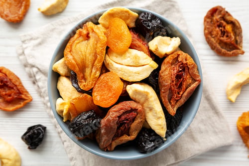 Preview: Organic healthy fruit mix in a bowl, top view. Flat lay, overhead, from above.