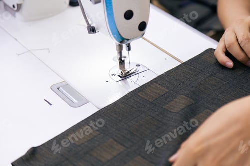 Preview: Tailor working on electric sewing machine