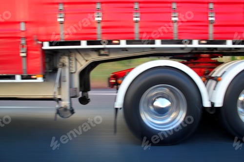 Preview: Big red truck driving past on the highway