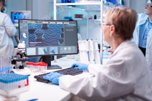 Preview: Medical scientist analyzing a test into computer for hospital expertise