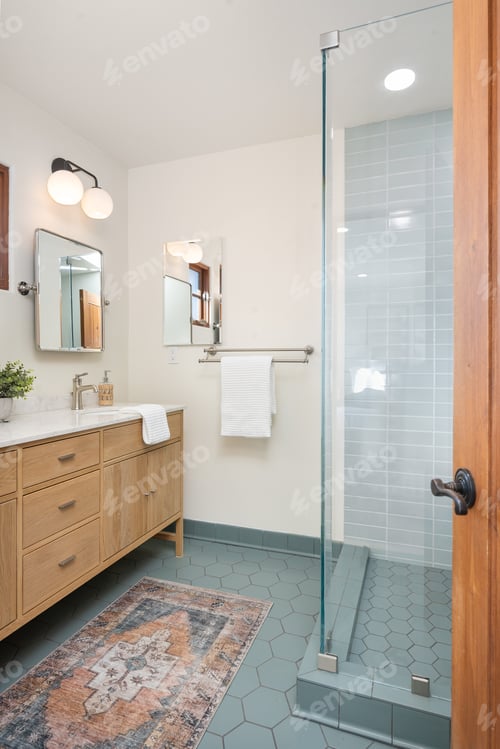 Preview: a bathroom with a blue rug on the floor and two large sinks, mirrors,