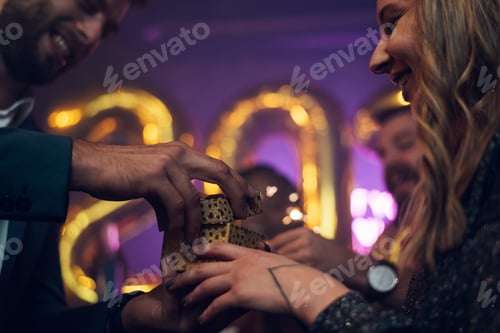Preview: Happy beautiful couple celebrate New Year's Eve and exchanging gifts
