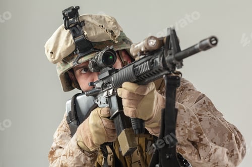 Preview: Soldier aims rifle while preparing for action in a training exercise indoors