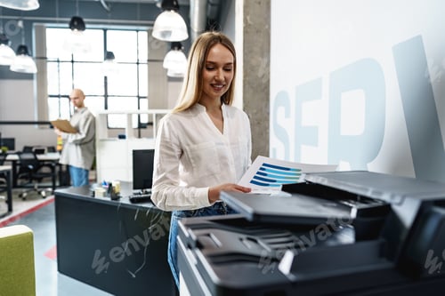 Preview: Young employee using modern printer in office