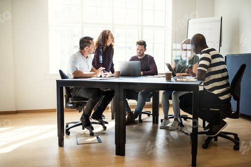 Preview: Designers having a meeting together around an office table