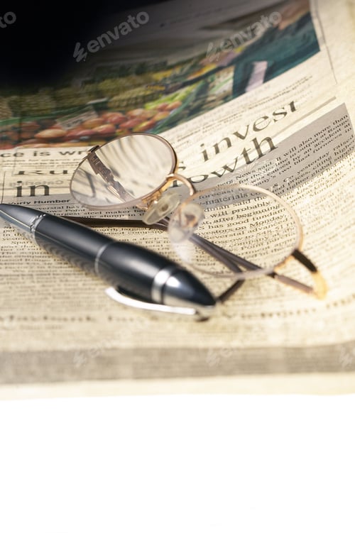 Preview: pen and glasses and newspaper