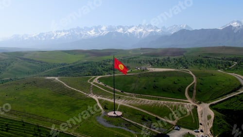 Preview: Aerial view of Bishkek city from the mountains. Flagpole with Kyrgyzstan flag