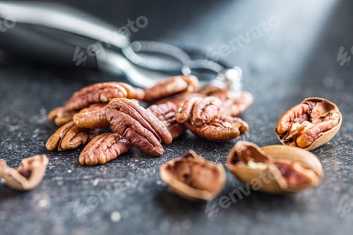 Preview: Peeled pecan nuts on kitchen table.