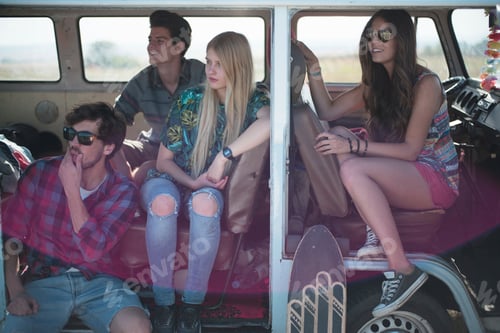 Preview: Friends enjoying a road trip in a vintage van.