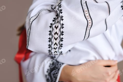Preview: The girl in an embroidered shirt. Closeup pattern on the sleeve.