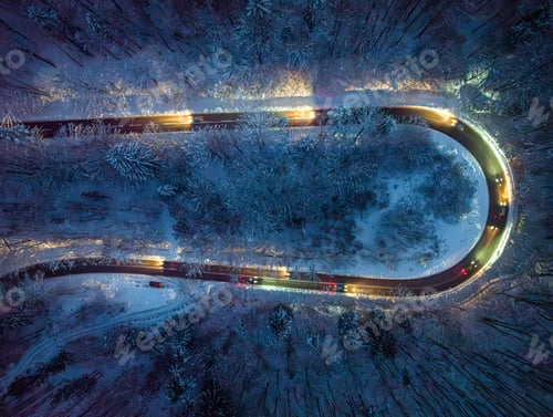 Preview: Driving cars with headlights on slippery winding road in winter.