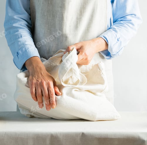 Preview: A woman in bright clothes holds a cotton bag made of natural fabric. Rustic natural style. Kinfolk