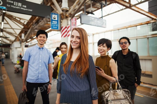 Preview: Small group of people standing on the platform of a subway station, Tokyo commuters.