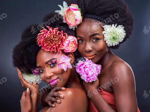 Preview: Cropped shot of two beautiful women posing together with flowers in their hair