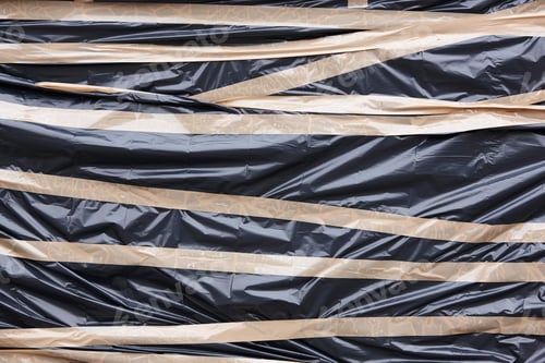 Preview: Black plastic protection with adhesive tape. Storage packaging. Horizontal