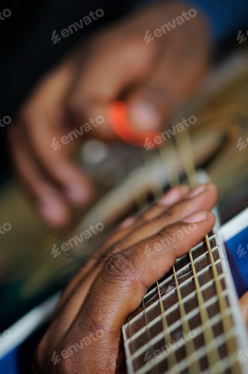 Preview: Young gen z black unrecognizable male musician guitarist closeup playing his guitar