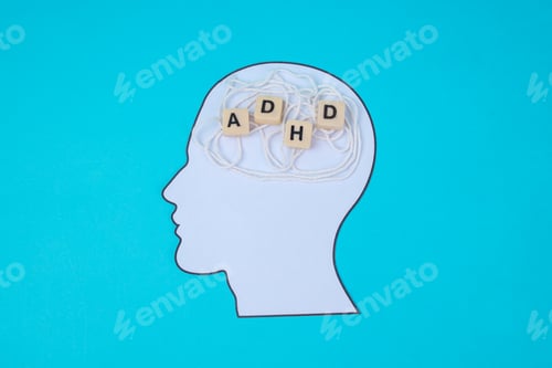 Preview: Mental Health Concept Of ADHD Showing Head Cutout With Scattered Thoughts On Blue Background