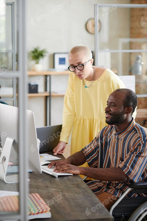Preview: Business partners working on computer at office