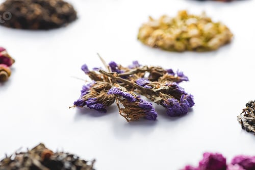 Preview: pattern of dried herbal natural tea on white surface