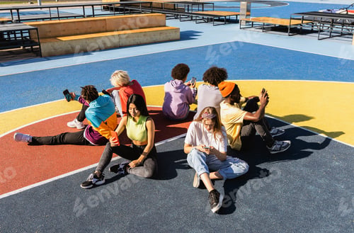 Preview: Multiracial group of young friends bonding outdoors