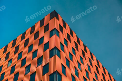 Preview: Modern office building exterior with glass facade on clear sky background. Transparent glass wall of