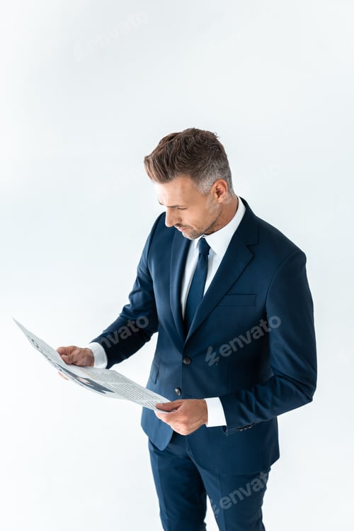 Preview: high angle view of handsome businessman reading newspaper isolated on white