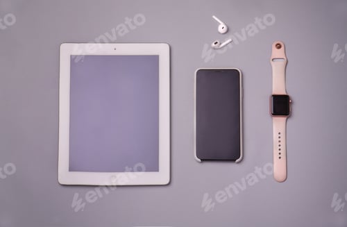 Preview: High angle shot of a tablet, a cellphone, a smartwatch, and earphones
