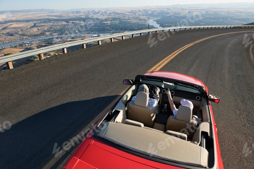 Preview: Young Caucasian couple on a road trip in their convertible sports car near Lewiston, Idaho USA.