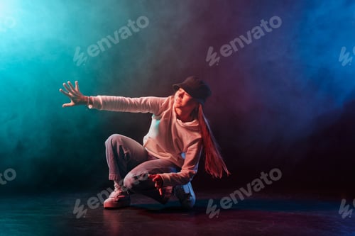 Preview: a girl in light clothes dances on a neon background in smoke, modern dance