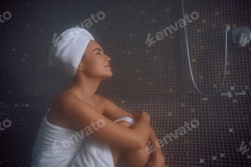 Preview: Young relaxed woman in steam room at health spa.