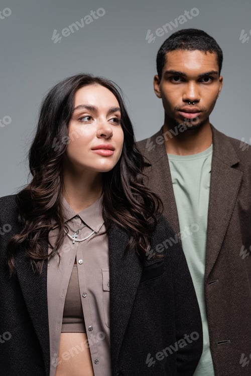 Preview: young african american man and brunette woman in stylish blazer isolated on grey