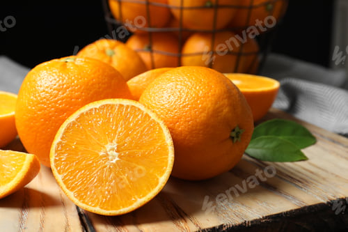 Preview: Wooden board with ripe oranges on table, closeup