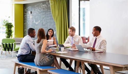 Preview: Five business colleagues in an informal meeting at work