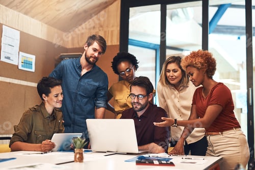 Preview: Shot of a diverse group of businesspeople working together on a laptop in an office