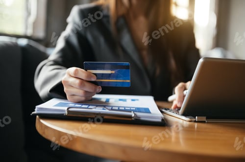 Preview: Hands using smartphone and holding credit card with digital layer effect