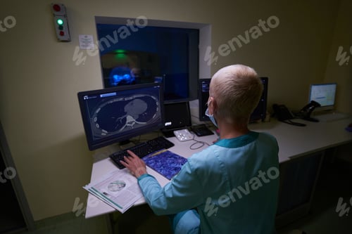 Preview: Doctor using computer during MRI of male patient
