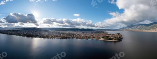 Preview: Greece, Ioannina city. Aerial view panorama of Giannena and Lake Pamvotis, cloudy blue sky.