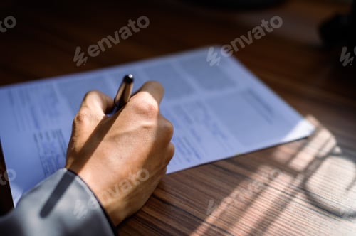 Preview: businessman reading and writing documents at work