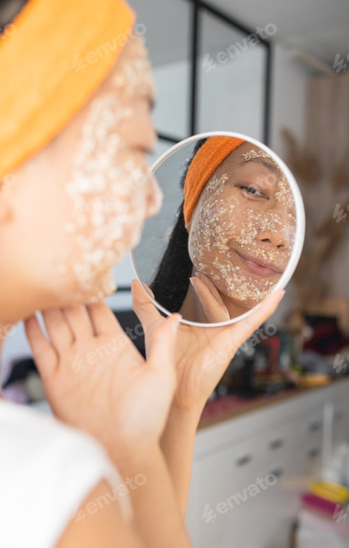 Preview: Portrait of a happy Asian woman using natural secrets for skin care (ingredients on the table: oats,