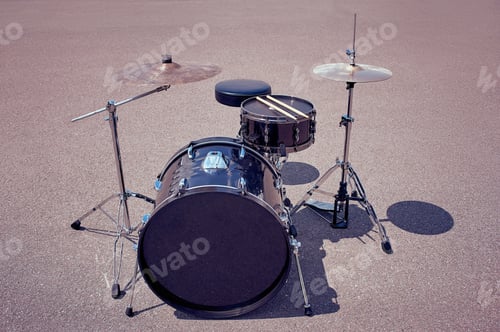 Preview: close up view of black drum kit and drum sticks on street