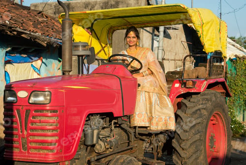 Preview: Beautiful Indian bride with tractor in village.