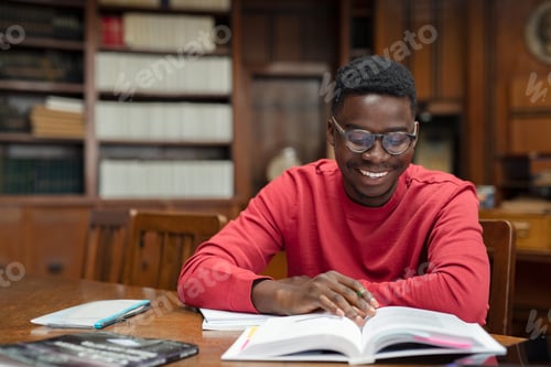 Preview: Happy university student reading in library