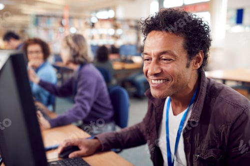 Preview: Group Of Mature Adult Students In Class Working At Computers In College Library