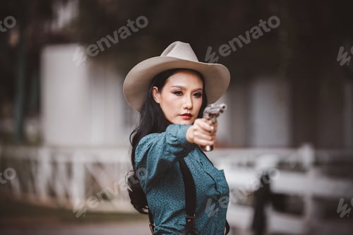 Preview: Cowboy posing shooting rifle by gun on hand to show protected weapon wearing cowboy dresser and hat