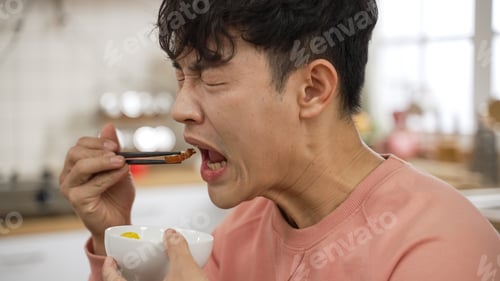 Preview: male making funny face tasting spicy food