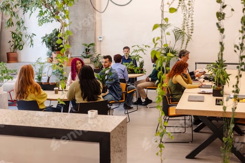 Preview: Diverse professionals working and collaborating in modern biophilic office