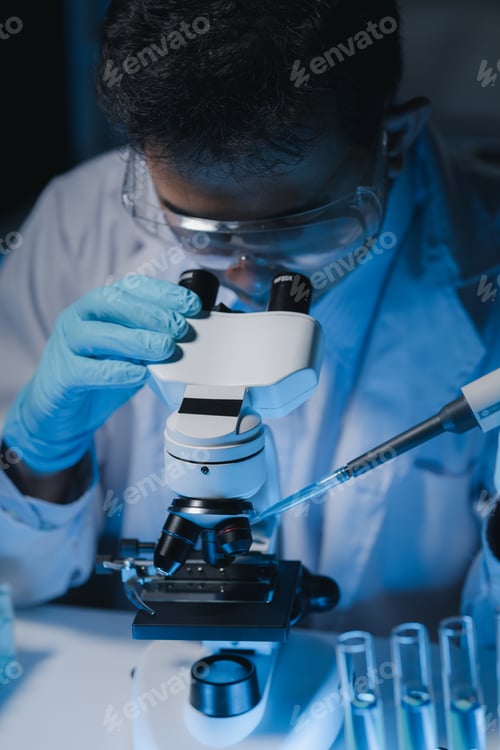 Preview: A scientist is studying samples using a microscope to study and develop the field of microbiology, M