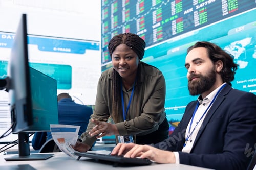 Preview: Team of diverse specialists review monthly cost and revenue elements